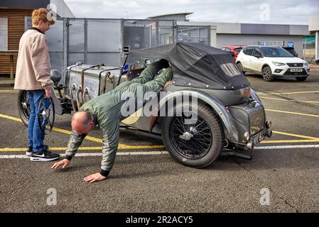 Frazer Nash 1936 vintage car with amusing scene of driver existing the vehicle which has no doors. England UK Stock Photo