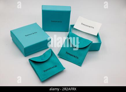 Tiffany & Co. blue jewellery boxes and pouches, isolated against white background. Famous American jewelry store business headquartered in New York Stock Photo