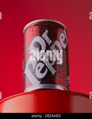 Studio image of a cold can of Dr Pepper shot on a red background,Mansfield,Nottingham,United Kingdom,may 30th 2023. Stock Photo