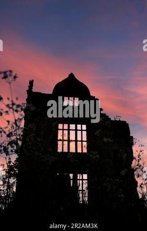 Silhouette of a house mansion in ruins and abandoned at sunset. Locally the house is said to be haunted Stock Photo