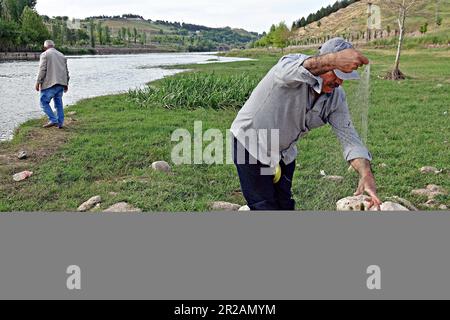 Man with fish caught on line hi-res stock photography and images