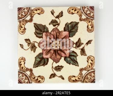 Antique 1890s Victorian hand coloured transfer printed pink flower pottery tile Stock Photo