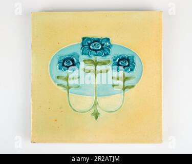 Antique 1900s Minton Art Nouveau blue flower pottery tile Stock Photo