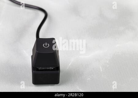 The separate Power button, Black button with Power icon, Power on off buttons for IT equipment isolated on reflection surface. Stock Photo