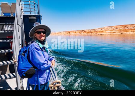 Senior female tourist enjoying boat tour; Lake Powell; Glen Canyon Dam; Glen Canyon National Recreation Area; Page; Arizona; USA Stock Photo