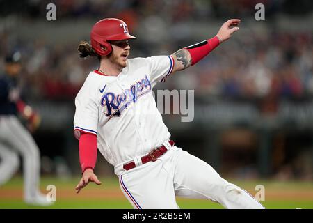 Houston Astros' Jeremy Pena, right, slides to score as Texas Rangers  catcher Jonah Heim, left, waits for the throw on a sacrifice fly by Yanier  Diaz during the fourth inning of a