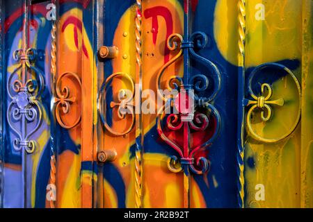 The door of the house smeared with the colors and paints of graffiti artists. Vibrant colors. Stock Photo
