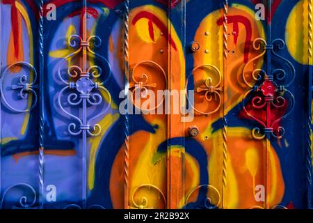 The door of the house smeared with the colors and paints of graffiti artists. Vibrant colors. Stock Photo