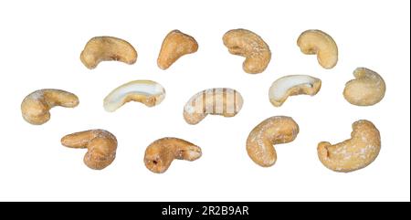 Set of whole or halved salty cashew nuts isolated on white background. Anacardium occidentale. Closeup a group of delicious roasted cashews with salt. Stock Photo