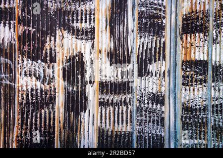 Street photograph of painted back alley corrugated steel wall. Stock Photo