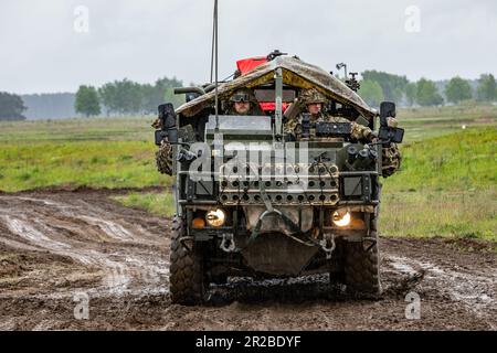 British soldiers assigned to the Royal Lancers Aliwal Troop maneuver an Jackal armored vehicle through the demonstration range during exercise Griffin Shock 23 live fire event in Bemowo Piskie, Poland, May 17, 2023. As the framework nation in Poland, Exercise Griffin Shock demonstrates the U.S. Army’s ability to assure the NATO alliance by rapidly reinforcing the NATO Battle Group Poland to a brigade size unit. (U.S. Army National Guard photo by Sgt. John Schoebel) Stock Photo