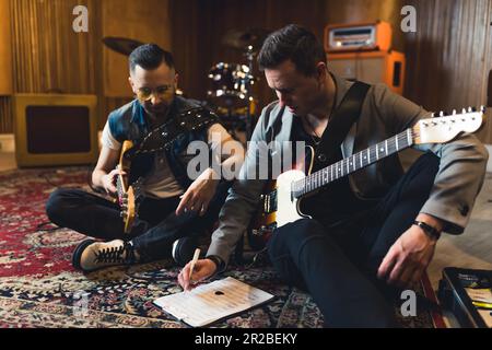 Young indie rock band playing the rehearsal before the concert . High quality photo Stock Photo