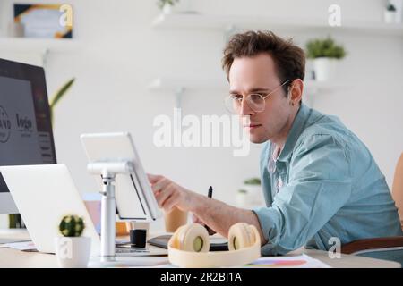 Male graphic designer developing logotype in office Stock Photo
