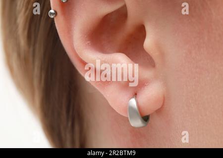 Woman with dry skin on white background, closeup of ear Stock Photo