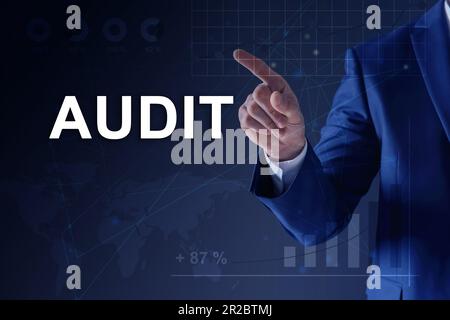 Audit concept. Businessman pointing at graph on dark blue background, closeup. Scheme and world map illustration Stock Photo