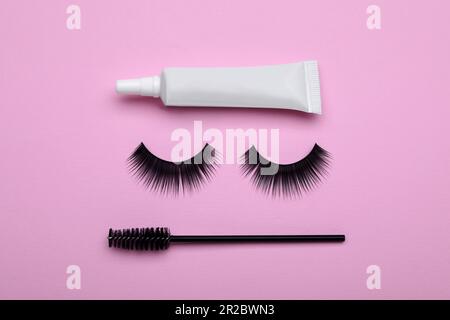 Flat lay composition with fake eyelashes on pink background Stock Photo