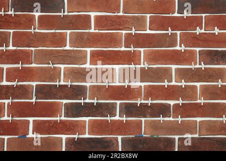 Decorative bricks with tile leveling system on wall Stock Photo