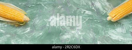 Yellow organic sweet corn on green marble malachite banner background Stock Photo