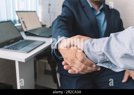 young manager handshake with new employee. close-up handshake. The concept of a perfect transaction in business. Stock Photo