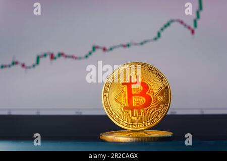 Close up golden Bitcoins mockup on tablet and stock chart background. Investment success Crypto currency Concept. Stock Photo
