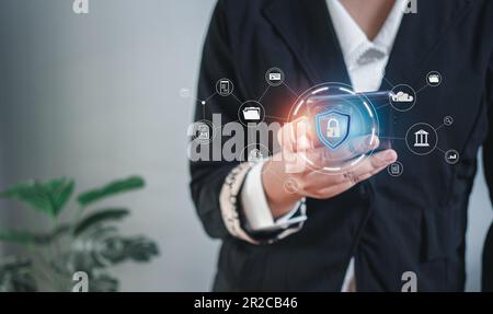 Businesswoman fingers are pressing on the phone screen. Represents protection against external hacks, code protection security concepts, viruses, firm Stock Photo