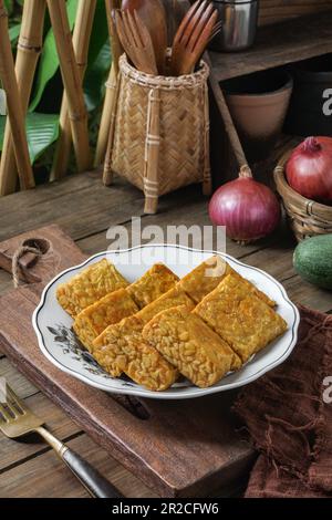 Fried Tempeh or Tempe is a traditional Malay dish snack popular in Malaysian, Indonesian, and Singapore Stock Photo