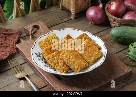 Fried Tempeh or Tempe is a traditional Malay dish snack popular in Malaysian, Indonesian, and Singapore Stock Photo