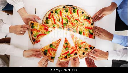 Friends Eating Pizza At Office Table Indoors Stock Photo