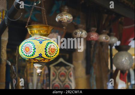 Turkey, a market with traditional colorful handmade Turkish lamps and lanterns, selective focus on a lantern, blurred background, lanterns hanging in Stock Photo