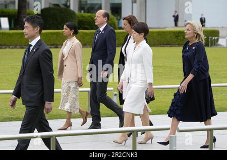 May 19, 2023, Hiroshima, Japan: An official leads (L-R) wife of British Prime Minister Rishi Sunak, Akshata Murty, husband of European Commission President Ursula von der Leyen, Heiko von der Leyen, wife of German Chancellor Olaf Scholz, Britta Ernst, Japan's First Lady Yuko Kishida and US First Lady Jill Biden to a flower wreath laying ceremony at the Cenotaph for Atomic Bomb Victims in the Peace Memorial Park as part of the G7 Hiroshima Summit in Hiroshima, Japan, 19 May 2023. (Photo by Franck Robichon/Pool) The G7 Hiroshima Summit will be held from 19 to 21 May 2023. (Credit Image: © POOL Stock Photo