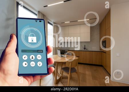 Internet of things, iot, smart home, kitchen and network connect concept. Human hand holding phone and smart home application to count power usage Stock Photo