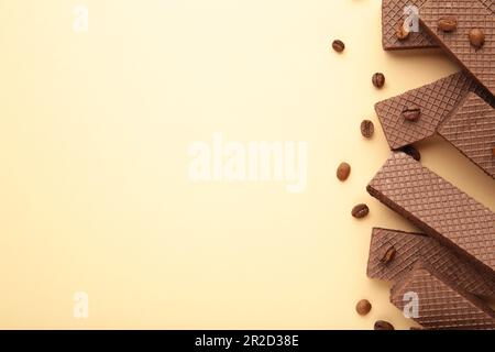 Chocolate wafers with coffee on beige background. Top view Stock Photo