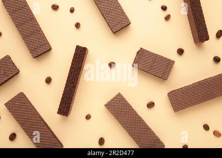 Chocolate wafers with coffee on beige background. Top view Stock Photo