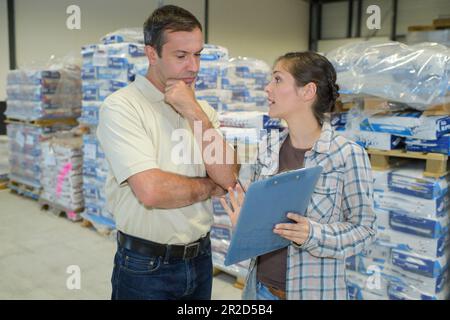 warehouse manager checking inventory in a large warehouse Stock Photo