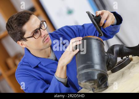 auto mobile mechanic with a piece to changer Stock Photo