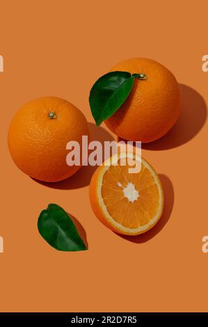 fresh juicy orange on an orange background Stock Photo