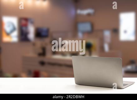 The back of the laptop is blank, placed on a white desk, and nobody, no people. Technology work concept, smartphone, notebook, internet, left side cop Stock Photo
