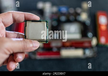 Closeup, Man holding CPU (Central processor Unit), Concept for fix, repair, mend,  restore, service, cobble, retrieve, recondition, selective focus, c Stock Photo