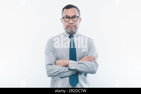 40-50 years old Asian businessman look at camera and folded his arms and smiled happily after successfully investing in finance, banking, real estate. Stock Photo