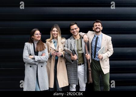 Group of young business people colleagues freelancers experts leaders of different professions in a company of marketing and financial experts standin Stock Photo
