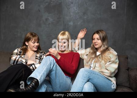 Three young candidates are waiting in the waiting room for a job interview. Group of women sitting and waiting to be called to the employment office Stock Photo