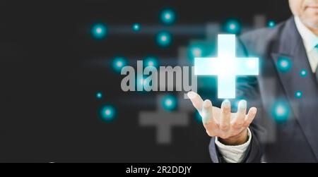 professional Businessman hand holding symbol cross shape with the shield icon and over gradient light blue, copy space on left, Business healthy and m Stock Photo