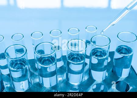 Chemistry experiment concept in science lab scientific chemistry glass vials of different sizes contain different chemicals. The chemicals are in many Stock Photo