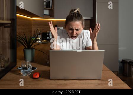 Young stressed hurt sad and shocked woman feeling betrayed finding out boyfriend husband is cheating on her by reading his messages and emails on lapt Stock Photo