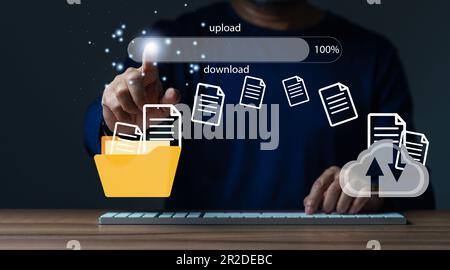 businessman upload documents from computer to backup online cloud and download copy file data from cloud network for makework in office or from home. Stock Photo