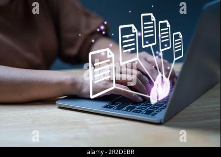 Businessman using laptop with virtual screen to backup data. Process data and manage files on cloud server efficiently. Online document database syste Stock Photo