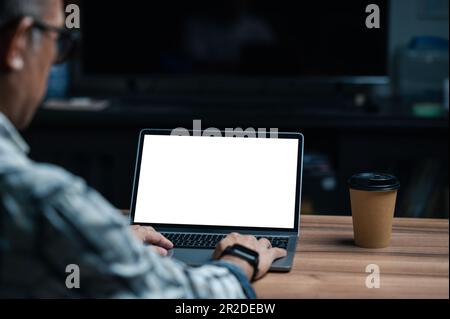 Close up hands of Businessman on laptop computer with a white blank screen. Programmer coding developer app for business company and require customer. Stock Photo