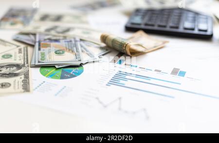business graph chart paper pen calculator us dollar on office desk. Checking financial reports. Stock Photo