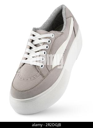 Gray casual sneaker with high sole stands on the tip isolated on white background with clipping path. Full Depth of Field Stock Photo
