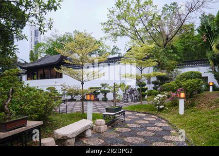 Hong Kong, China - April 10 2023: Bonsai Garden of Kowloon Walled City Park with it's traditional Chinese Architecture Stock Photo